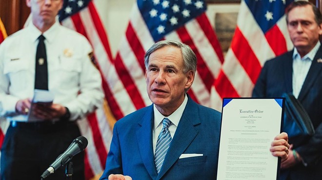 Texas Gov. Greg Abbott shows off an order signed during the coronavirus pandemic.
