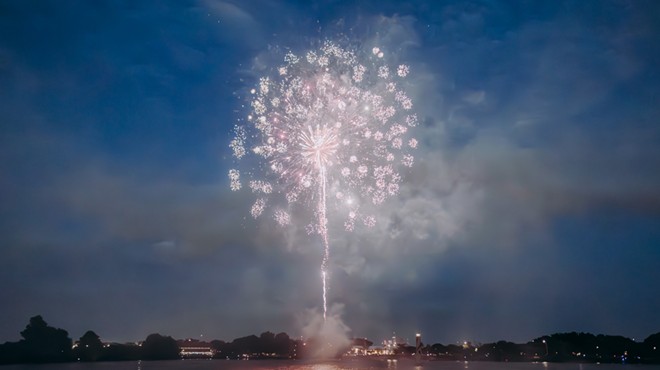 Fireworks light up the sky over Woodlawn Lake during its 2023 Independence Day celebration.