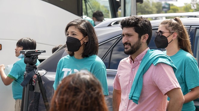 Greg Casar (in pink shirt) attends a protest on behalf of residents of a San Antonio apartment complex.