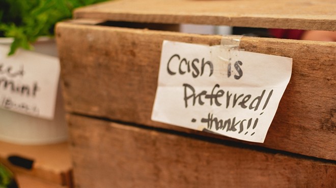 A small business' sign alerts customers that cash is its preferred payment.