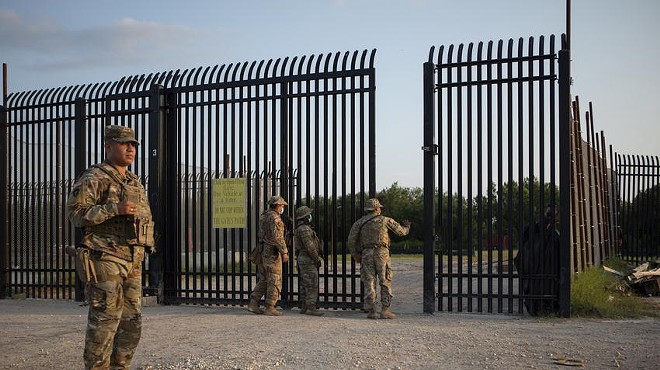 National Guard soldiers stand guard near the U.S.-Mexico border in Del Rio.