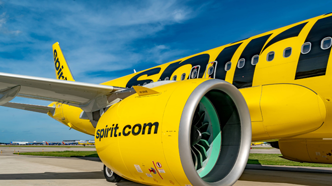 A Spirit airlines A319 sits on a tarmac.