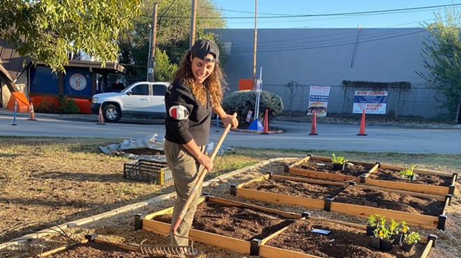 Jess Rivera helps build a garden in front of Little Death Wine Bar.