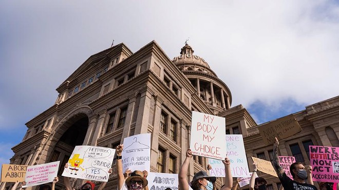 Protesters stand at the front steps of the state Capitol in opposition to Texas' abortion restrictions law on Oct. 2, 2021.