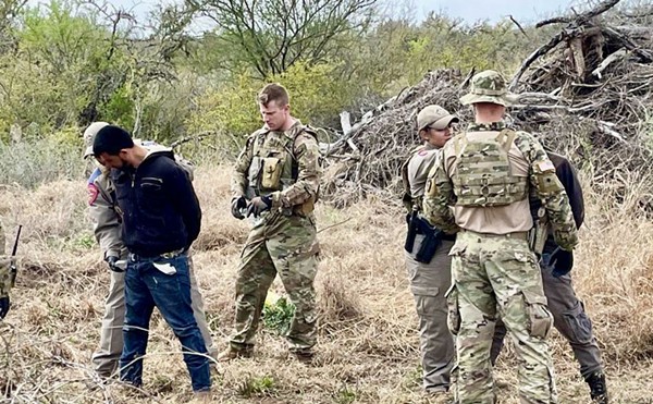Texas law enforcement personnel apprehend a migrant in South Texas as part of Operation Lone Star.