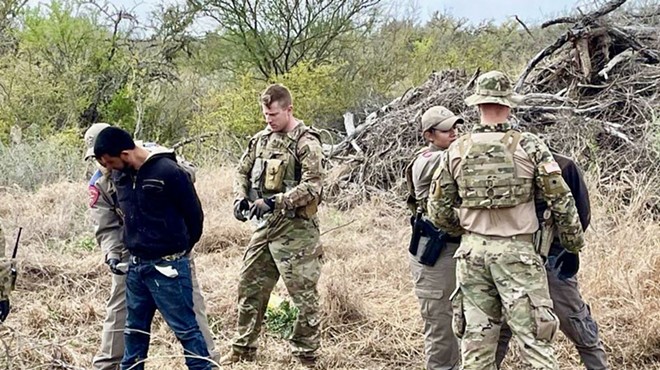 Texas law enforcement personnel apprehend a migrant in South Texas as part of Operation Lone Star.