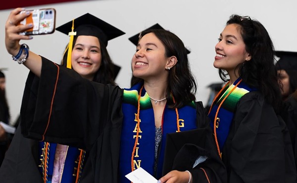 Graduates take a selfie prior to the University of Texas at Austin Latinx Graduation on May 9, 2024 in Austin. The graduates received orange chords, a nod to the color of monarch butterflies that symbolize the resilience of Latinx immigrants. Credit: Maria Crane/The Texas Tribune