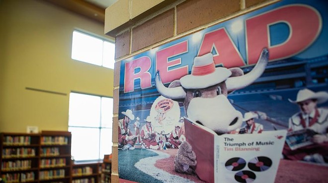 A poster encouraging students to read hangs on a wall at Vandegrift High School’s library in Leander on March 2, 2022.