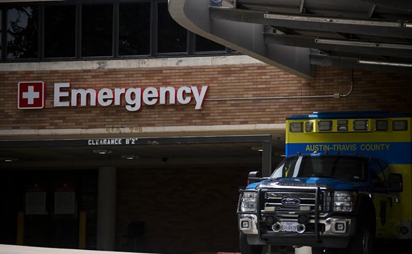 An Austin-Travis County EMS unit parked near a hospital's emergency entrance in Austin on July 7, 2020.