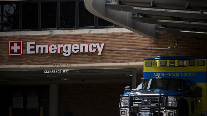 An Austin-Travis County EMS unit parked near a hospital's emergency entrance in Austin on July 7, 2020.