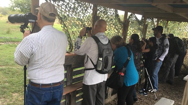 Bird-watchers engage in their hobby at the National Butterfly Center, which has been threatened by right-wing extremists.