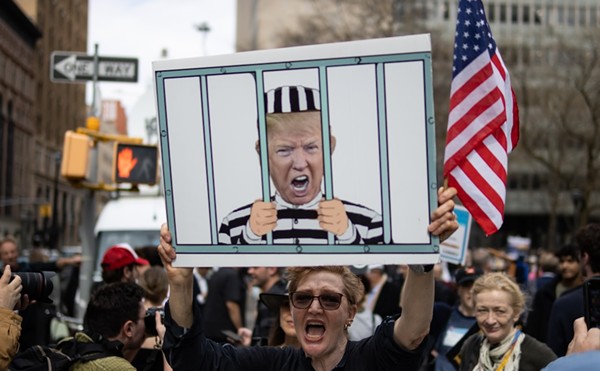 A woman protests outside of a New York City courthouse ahead of former President Donald Trump's indictment in April 2023.