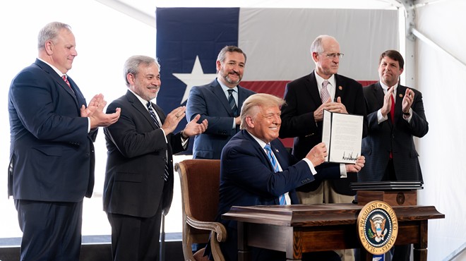 Donald Trump shows off his signature on federal permits during an appearance in Midland this summer.