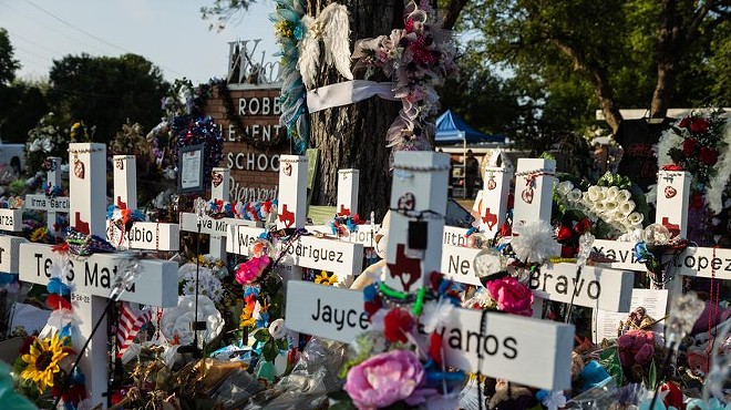 Hundreds of flowers, toys and candles surround a memorial in June for the 21 victims killed in the Robb Elementary shooting in Uvalde.