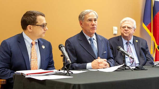 Gov. Greg Abbott (center) appears with State Rep. Briscoe Cain (left) and Sen. Paul Bettencourt, Republican lawmakers who pushed the state's restrictive new voting laws.