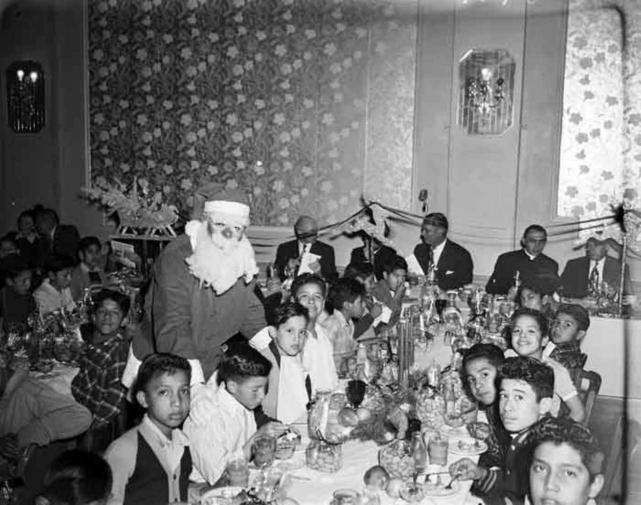 Santa made the rounds at the Newsboys' Christmas Dinner, probably finding out just what everyone wanted to find under the tree on Christmas morning!