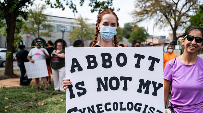 A protester at a San Antonio rally in defense of reproductive rights shows off her sign.