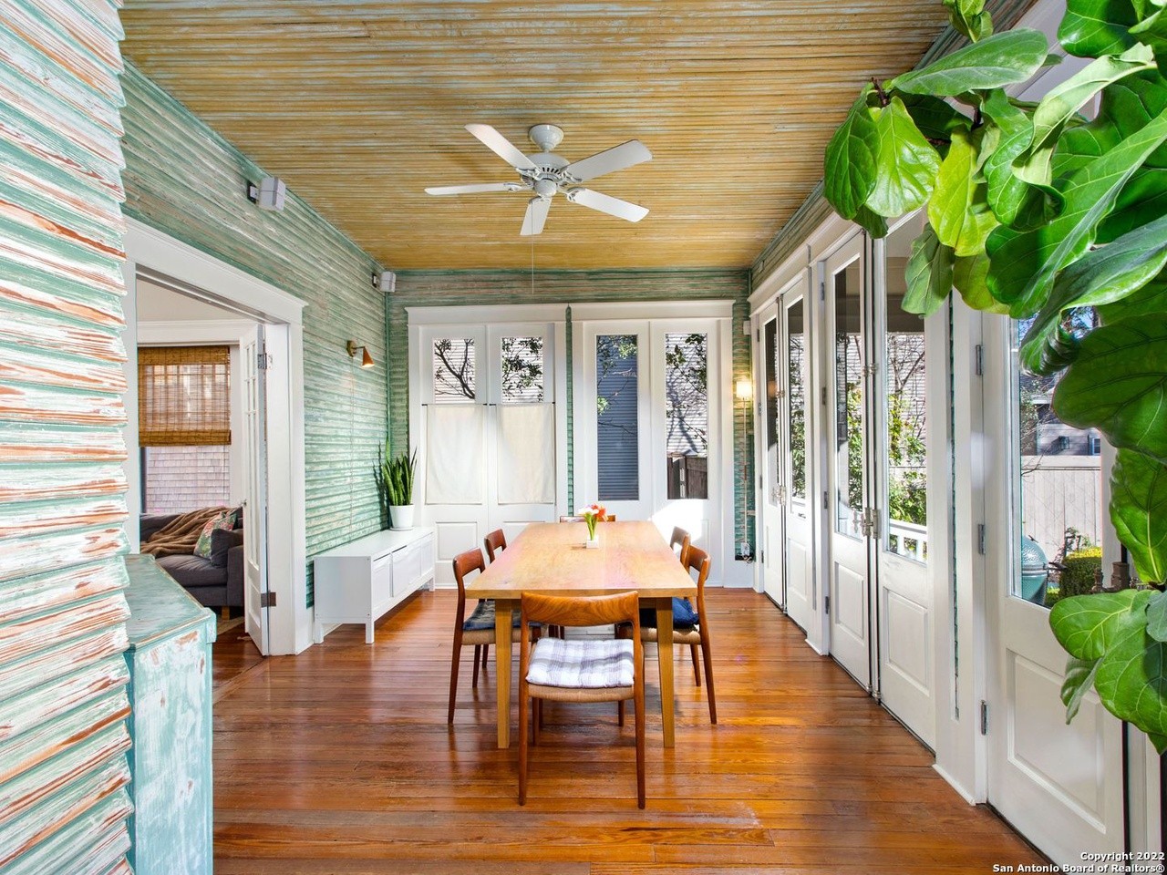 This restored 1913 San Antonio home includes a dining area that opens into a sunroom