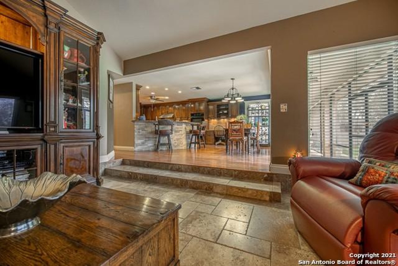 This West San Antonio home comes with a rare completely screened-in pool