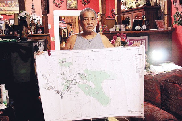 Toxic Triangle resident Robert Alvarado with a map of the contaminated groundwater plume. - Michael Barajas