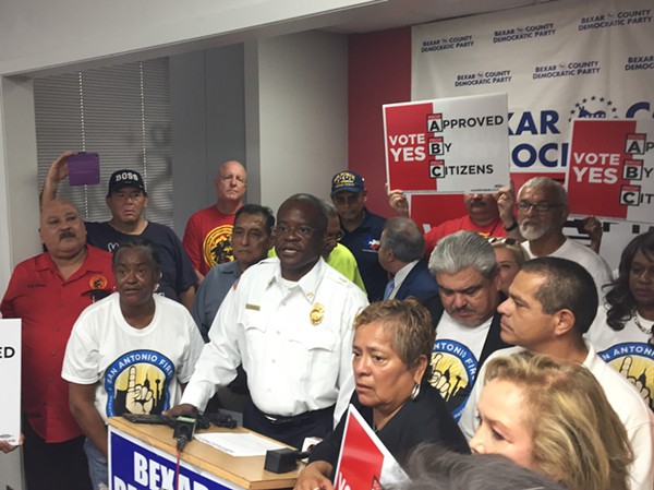 Chris Steele speaks at the Bexar County Democratic Party headquarters. That's not a real firefighters shirt he's wearing. - SANFORD NOWLIN