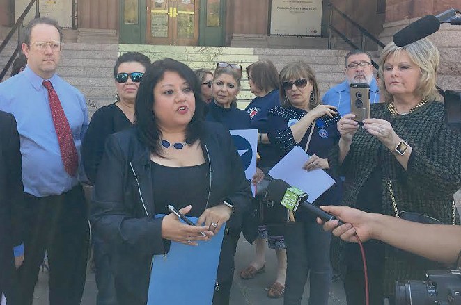 Bexar County Democratic Party Chairwoman Monica Alcantara speaks to the press outside the Bexar County Courthouse. - SANFORD NOWLIN