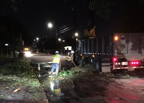 A cleanup crew removes debris from a roadway following Thursday's thunderstorm. - TWITTER / @MAXMASSEYTV