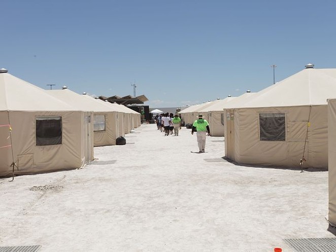 Staff and detainees walk between the tents inside the Tornillo, Texas, detention center for immigrant children, which closed earlier this year. - U.S. DEPARTMENT OF HEALTH AND HUMAN SERVICES