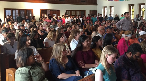 People at a San Antonio town hall on domestic violence listen to a survivor share  her story. - Sanford Nowlin