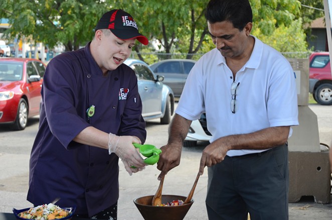 L to R: San Antonio Food Bank Chef Kelly Daughety and Gas N' Go Owner Shaukat Momin demo a healthy salad recipe, using fresh produce available to District 3 residents. - Lea Thompson