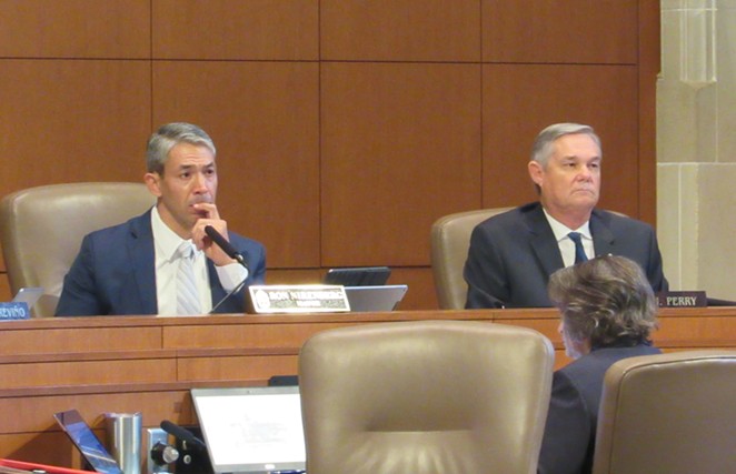 Mayor Ron Nirenberg (left) and Councilman Clayton Perry listen to a speaker at Thursday's meeting. Nirenberg championed the Climate Action & Adaption Plan, while Perry cast the sole vote against it. - RHYMA CASTILLO