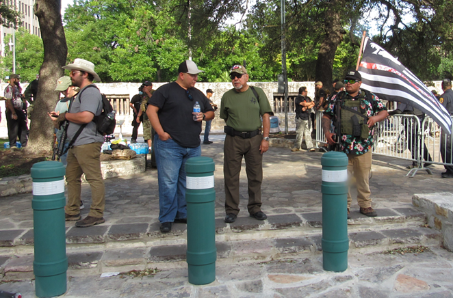 Texas Is Texas Freedom Force protesters stand in front of the Alamo Cenotaph. - SANFORD NOWLIN