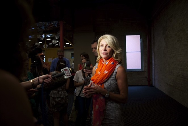Wendy Davis speaks with reporters at a #StandWithTXWomen rally. - JENELLE ESPARZA