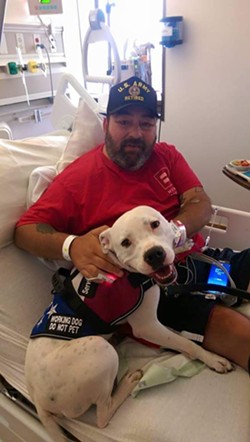 Here's Edwin Patterson recovering with his service dog, Langton, after doctors amputated one of his legs. - Team Pluto