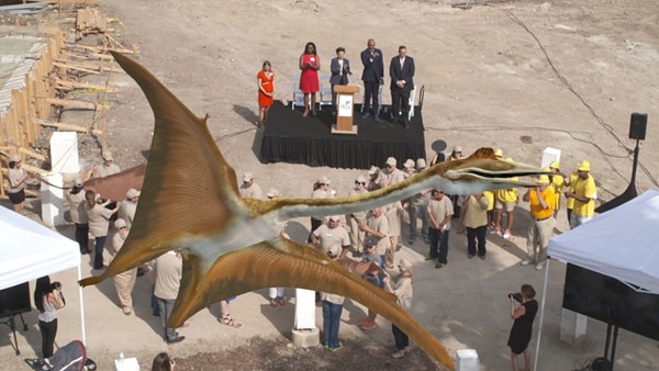 A planned "flash mob" formed a scale replica of "Quetzy," a Quetzacoatlus northropi — the largest known flying animal — at a press conference Tuesday where the Witte Museum unveiled plans for its new entrance, which will feature the dinosaur. - SCREEGRAB