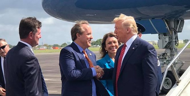 Texas AG Ken Paxton (center) does the ol' grip-and-grin with President Donald Trump during the president's visit to Houston. - FACEBOOK / KEN PAXTON
