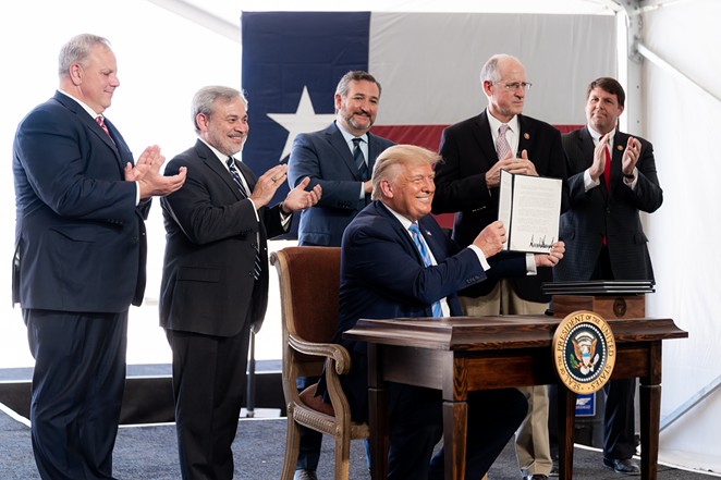 Donald Trump shows off his signature on federal permits during an appearance in Midland this summer. - Courtesy Photo / The White House