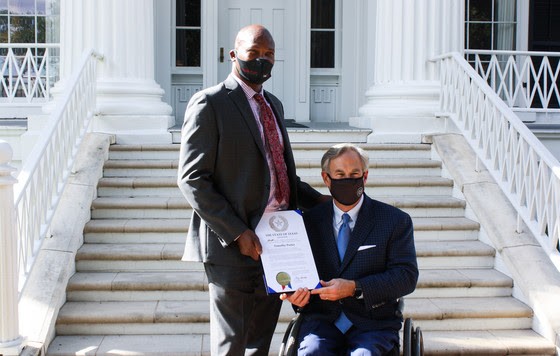 Timothy Porter of San Antonio (left) receives a recognition from Gov. Greg Abbott. - Office of the Governor