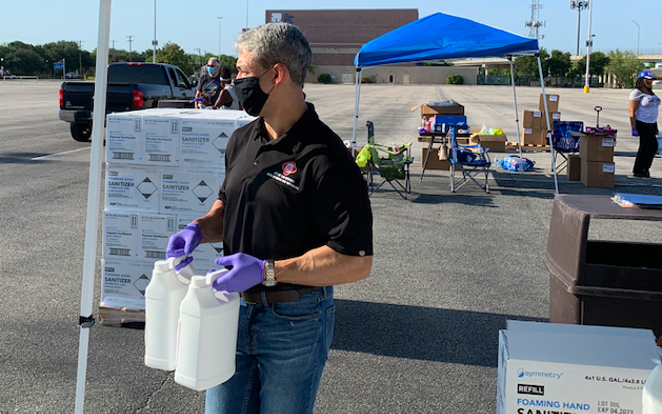 Mayor Ron Nirenberg helps hand out sanitizer to small businesses during an event this summer. - TWITTER / @RON_NIRENBERG