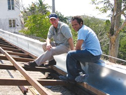 William Dupont and Cuban architect Adanelio Benavides Ramos review the roof and gutter assembly on Hemingway’s House in 2006.