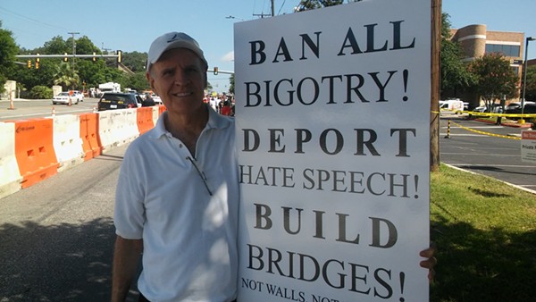 Mick Sullivan holds up a sign he made for the protest. - MICHAEL MARKS