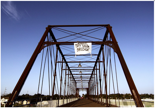 Activists climbed the Hays Street Bridge to hang a banner opposing development after plans for a brewery on public land emerged in 2012.