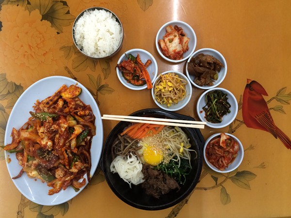 Clockwise from L-R: Charbroiled squid, rice, assorted banchan, stone pot bibimbap