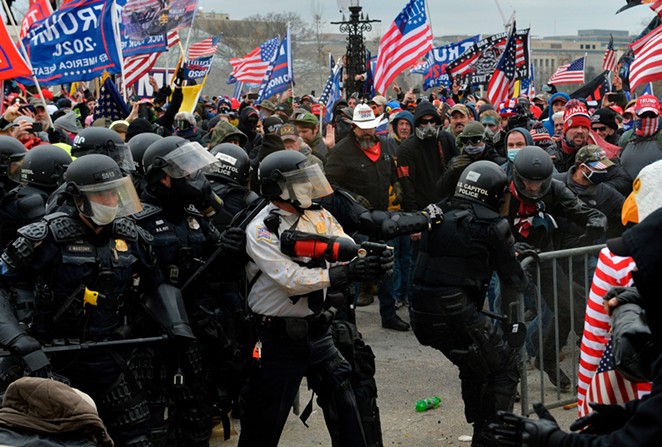 Police battle with supporters of Donald Trump as they breach barriers around the U.S. Capitol on January 6. - SHUTTERSTOCK