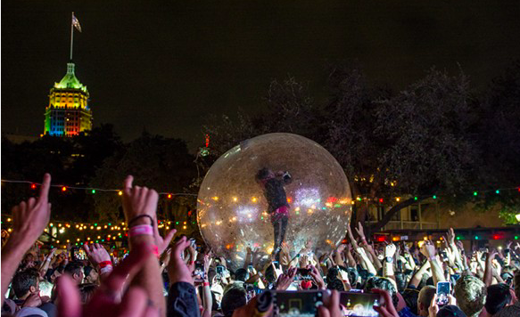 The Flaming Lips' Wayne Coyne belts it out from inside a plastic bubble during the band's 2016 performance at the Maverick Music Festival. - JAIME MONZON