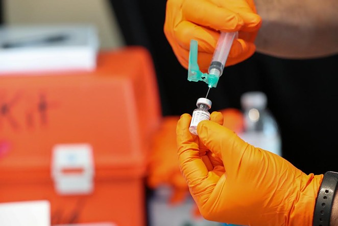 A health worker at a San Antonio vaccination site fills a syringe. - COURTESY / CITY OF SAN ANTONIO