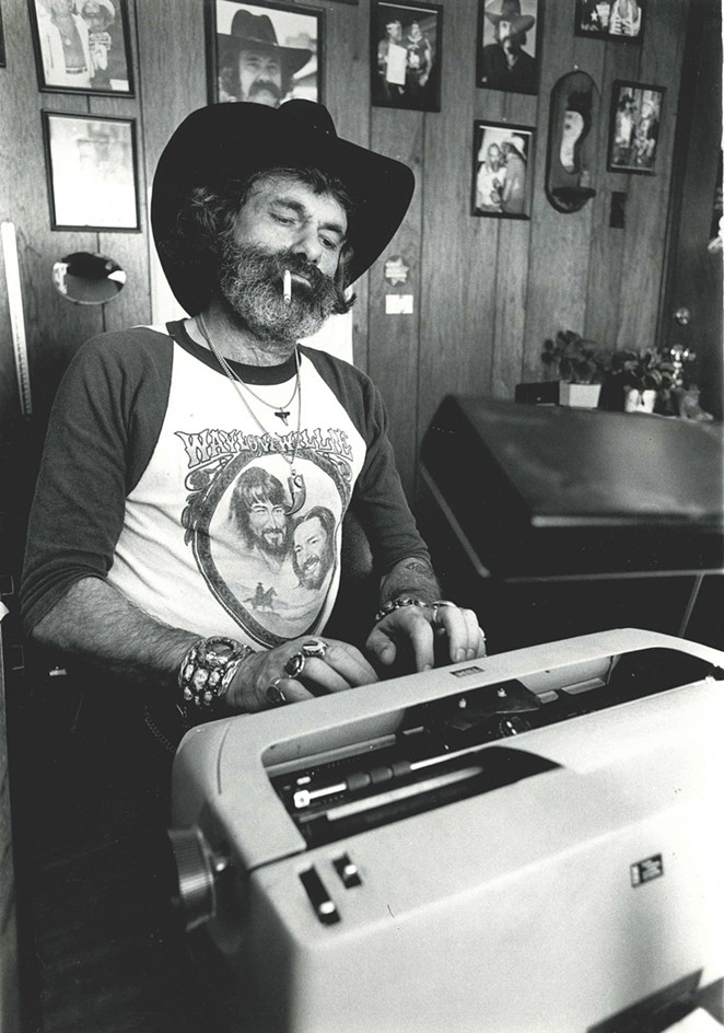Action Magazine's Sam Kindrick, pictured sitting at a typewriter. - SAM KINDRICK COLLECTION, THE WITTLIFF COLLECTIONS