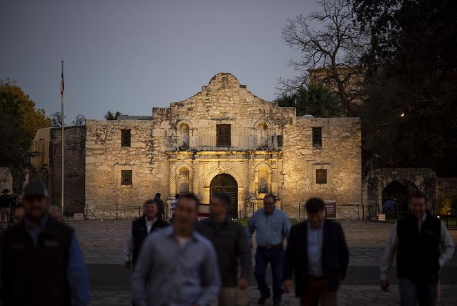Visitors cross the street away from the Alamo in San Antonio. - Texas Tribune / Eddie Gaspar