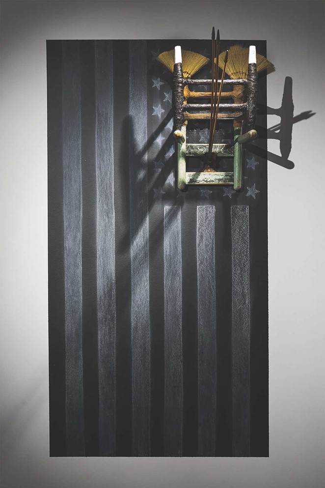 Ariel René Jackson, The next life of property, 2019, chair erected onto chalk rendering of US flag; Tampico broom corn via Mexico, Texas sourced soil, chalkboard paint, concrete, 60 x 36 x 48 in. - Image courtesy the artist. © Ariel René Jackson 2019.