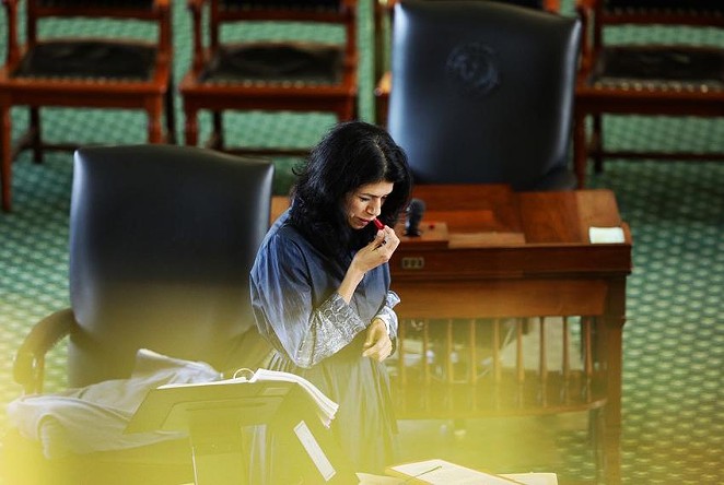 State Sen. Carol Alvarado, D-Houston, applies lipstick in her 15th hour of filibustering against Senate Bill 1. - Texas Tribune / Miguel Gutierrez Jr.